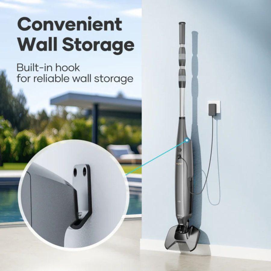 Vacuum cleaner with a built-in hook for wall storage next to a pool.