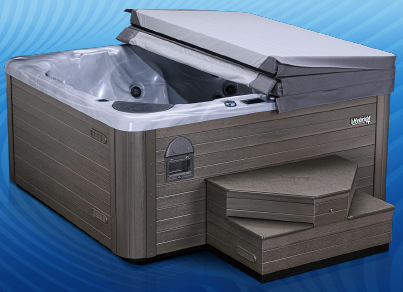 Close up of a beachcomber hot tub with two tiered stairs in front and cover folded over